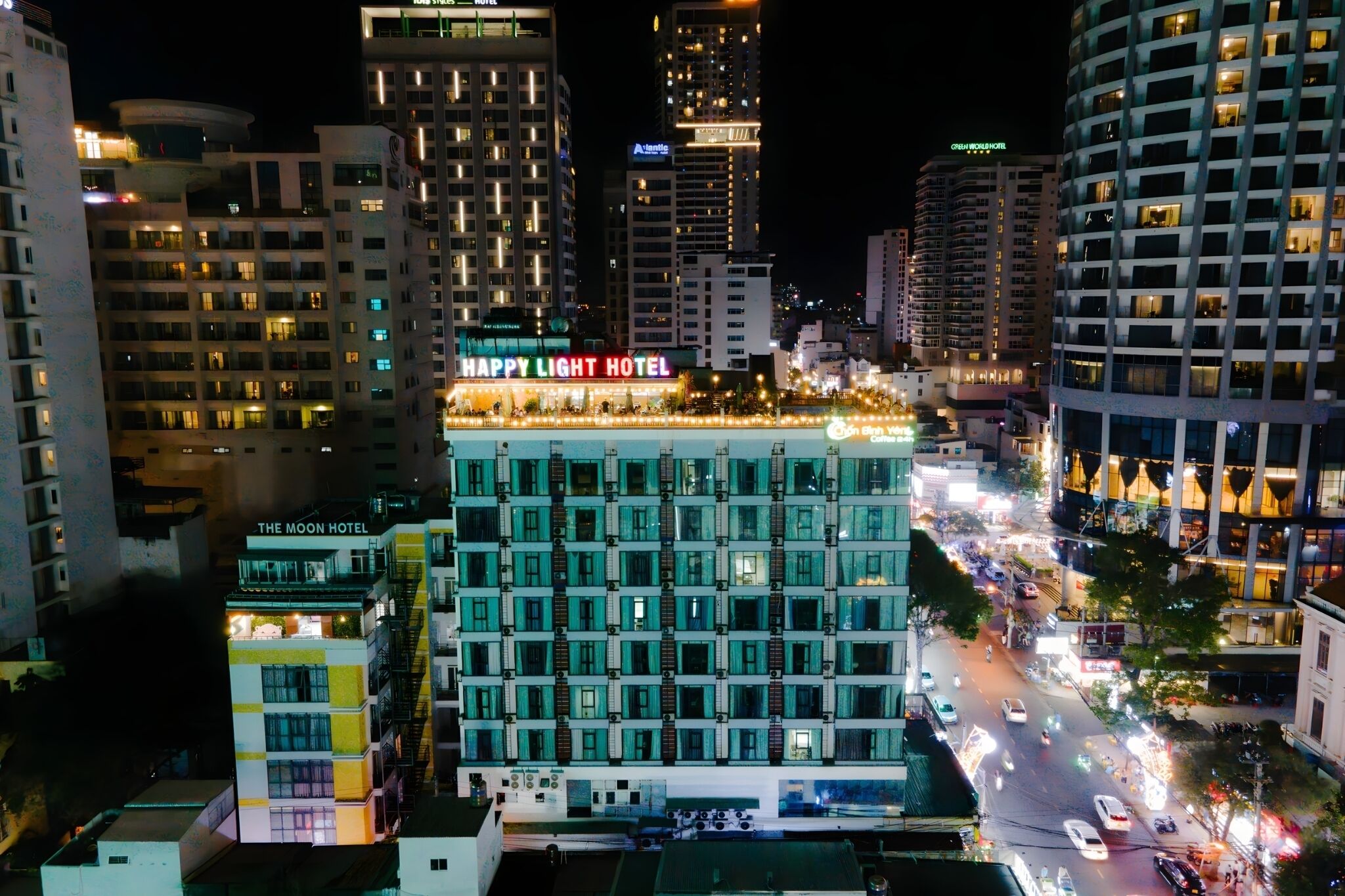 A multi-story hotel with a prominent sign reading "HAPPY LIGHT HOTEL" at the top.