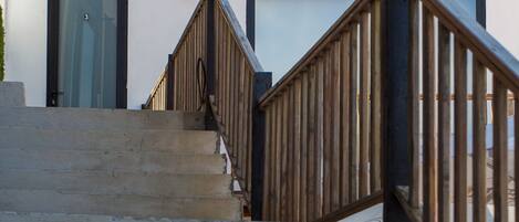 A staircase leading to a building labeled "Porto de Abrigo Guest House."