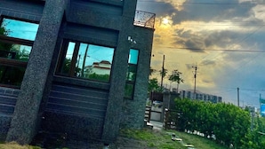 A modern multi-story building with large windows and a balcony. - Annabess (Wujie)