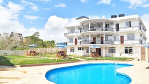 A multi-story building with a swimming pool in front. - Sea Crest Hotel (Kiwengwa)
