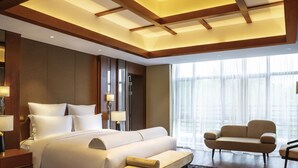 A modern hotel room with a large bed, a sofa, and a desk. - Pullman Changbaishan Resort (Baishan)