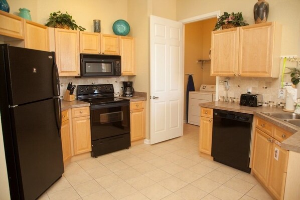 Family Condo, Kitchen, Garden Area | Shared kitchen | Fridge, microwave, oven