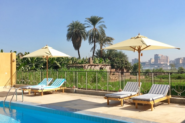 Outdoor pool, open 6:00 AM to 6:00 PM, pool umbrellas, sun loungers