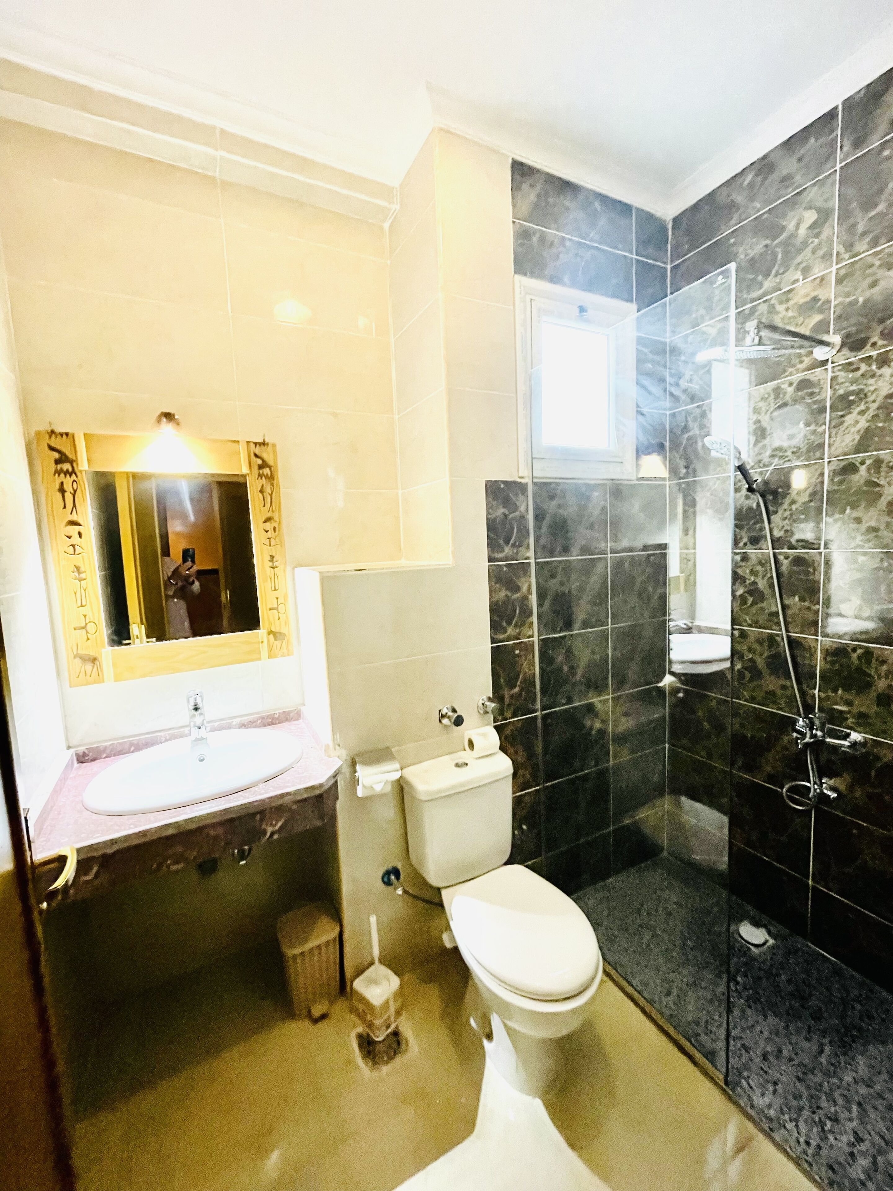 A bathroom with a sink, toilet, and shower.