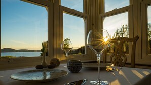 A table set for two with a view of the lake and mountains. - Summer Isles Hotel (Ullapool)