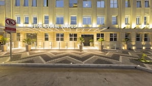 A hotel with a classic facade, multiple windows, and a well-lit entrance.