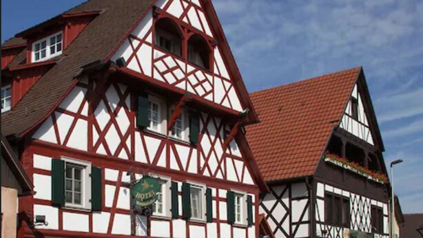 A traditional half-timbered building with a sign indicating a hotel. - Hotel Engel (Rheinmunster)