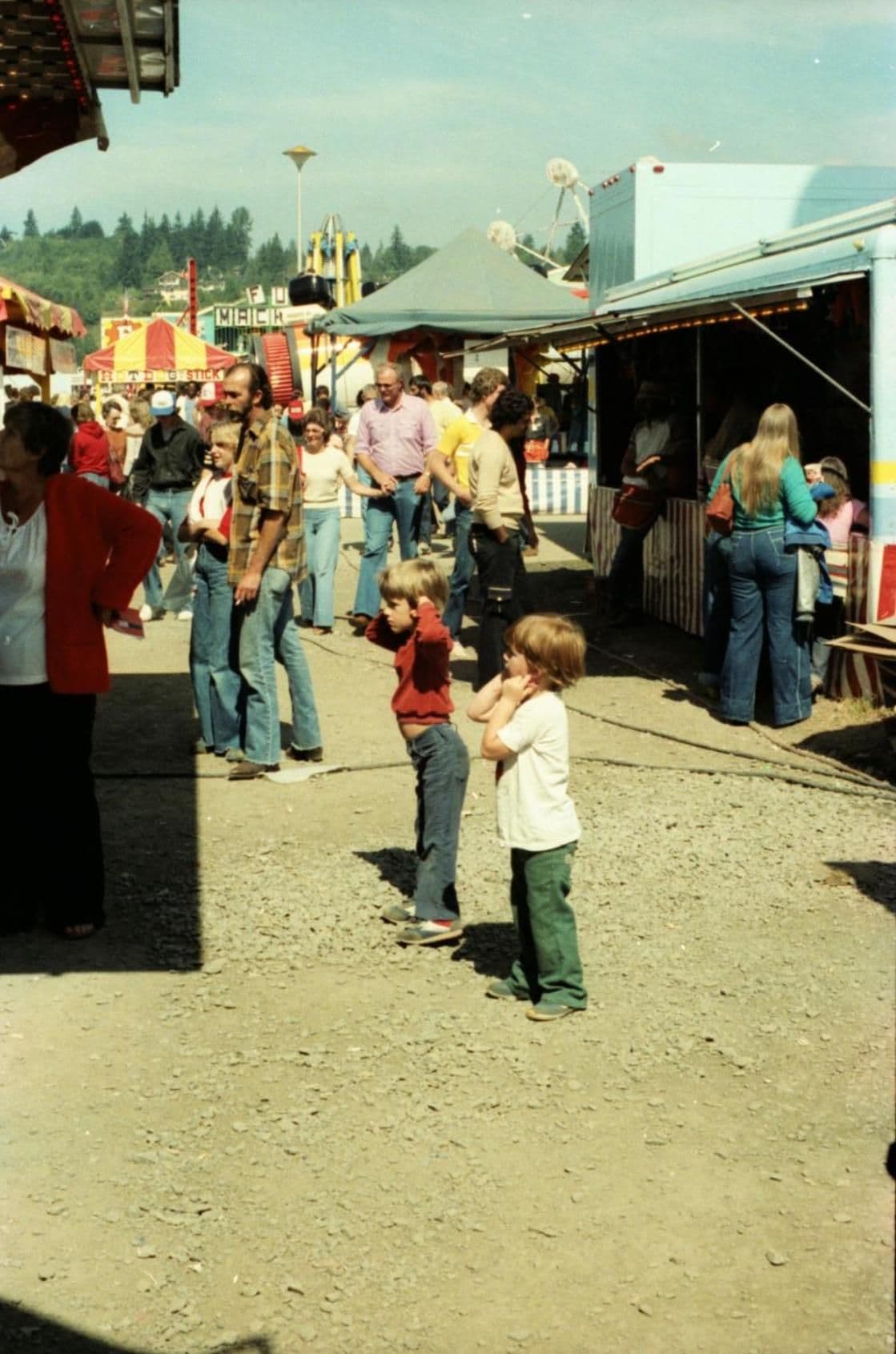 An outdoor market with people and stalls.