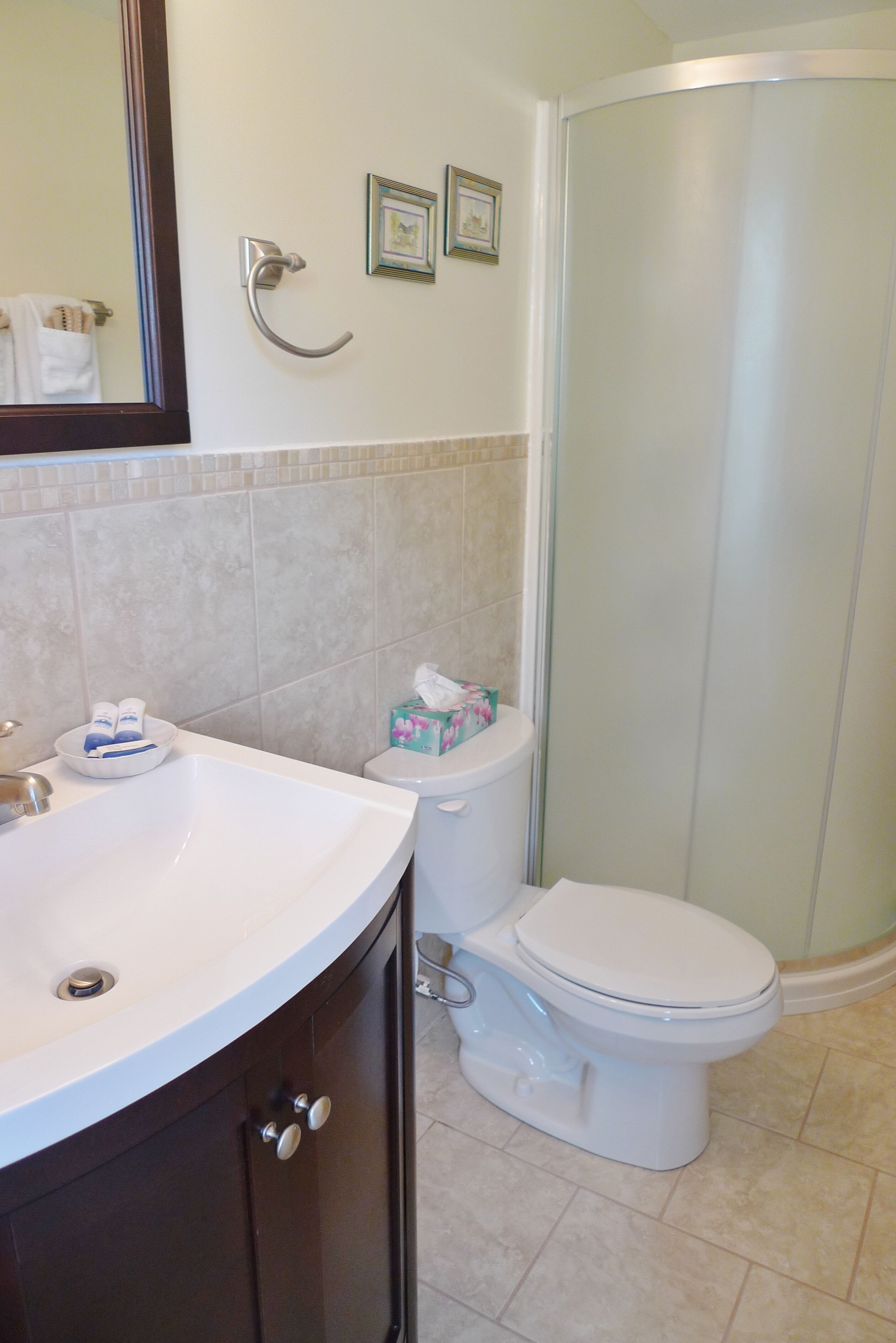 A bathroom with a sink, toilet, and shower.