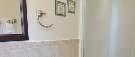 A bathroom with a sink, toilet, and shower.