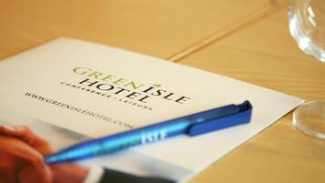Volantino dell'Hotel Green Isle con una penna sopra.