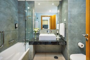 A modern bathroom with a glass-enclosed shower, a white sink, and a toilet. - Pestana DOM Joao Villas (Portimao)