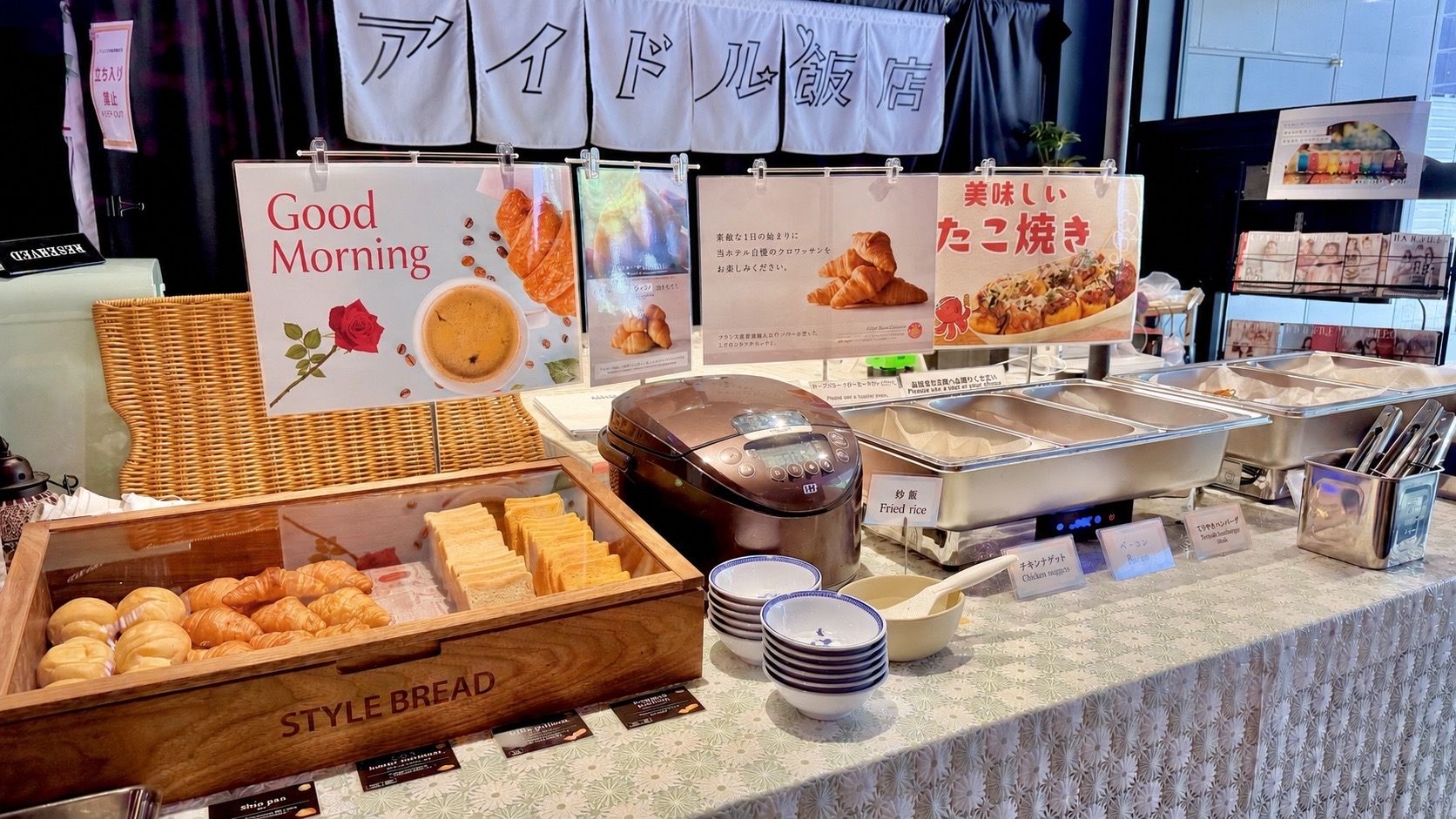 A breakfast buffet with various food items and a sign that reads 'Good Morning'.