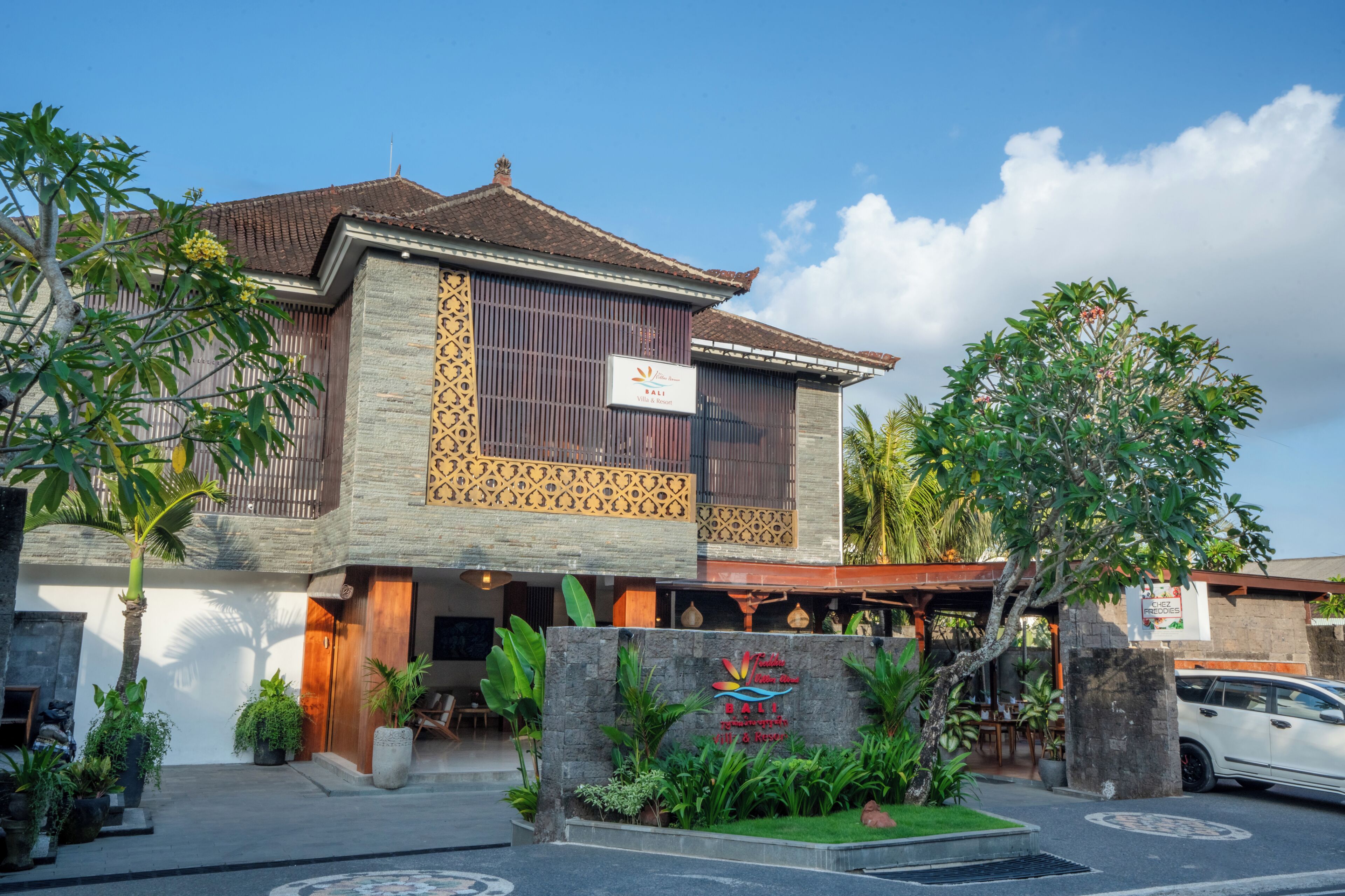 A two-story building with a traditional architectural style, featuring a tiled roof and a decorative facade.