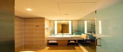 A modern bathroom with a glass shower enclosure, a large mirror, and a wooden vanity.