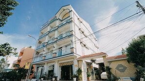 A multi-story hotel with a prominent entrance, balconies, and a tiled roof. - Tulip Hotel Can Tho (Can Tho)