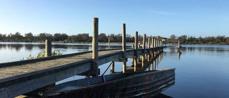 A calm lake with a wooden dock extending into the water.