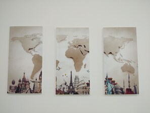Three vertical panels with a world map and iconic landmarks.