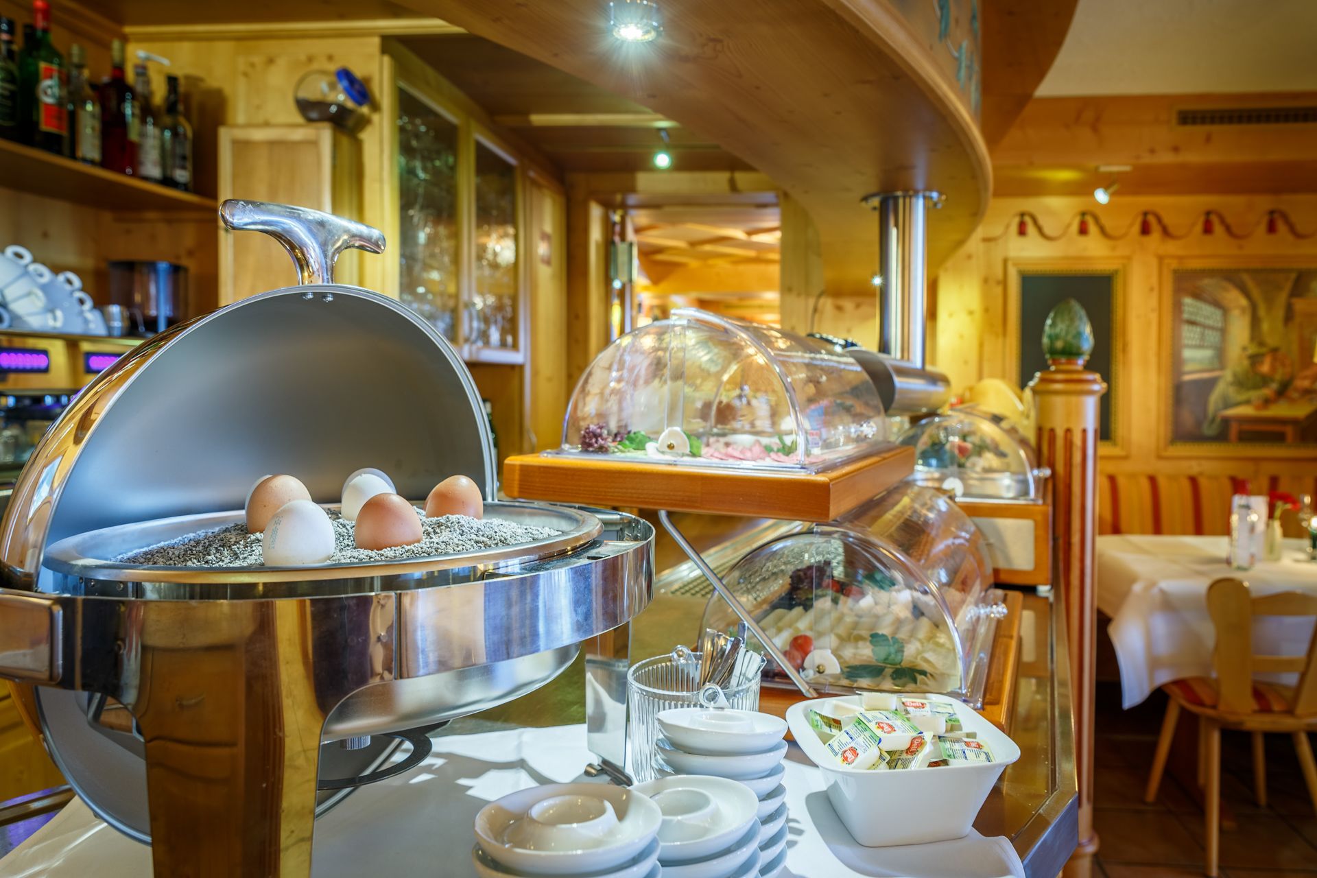 A breakfast buffet with various food items and a coffee station.
