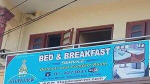 A sign for a bed and breakfast with a contact number and website.