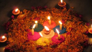 A circular arrangement of candles and flower petals.