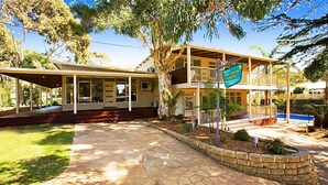 A two-story house with a covered patio and a swimming pool. - Beach House Units - 3 (Cowes)