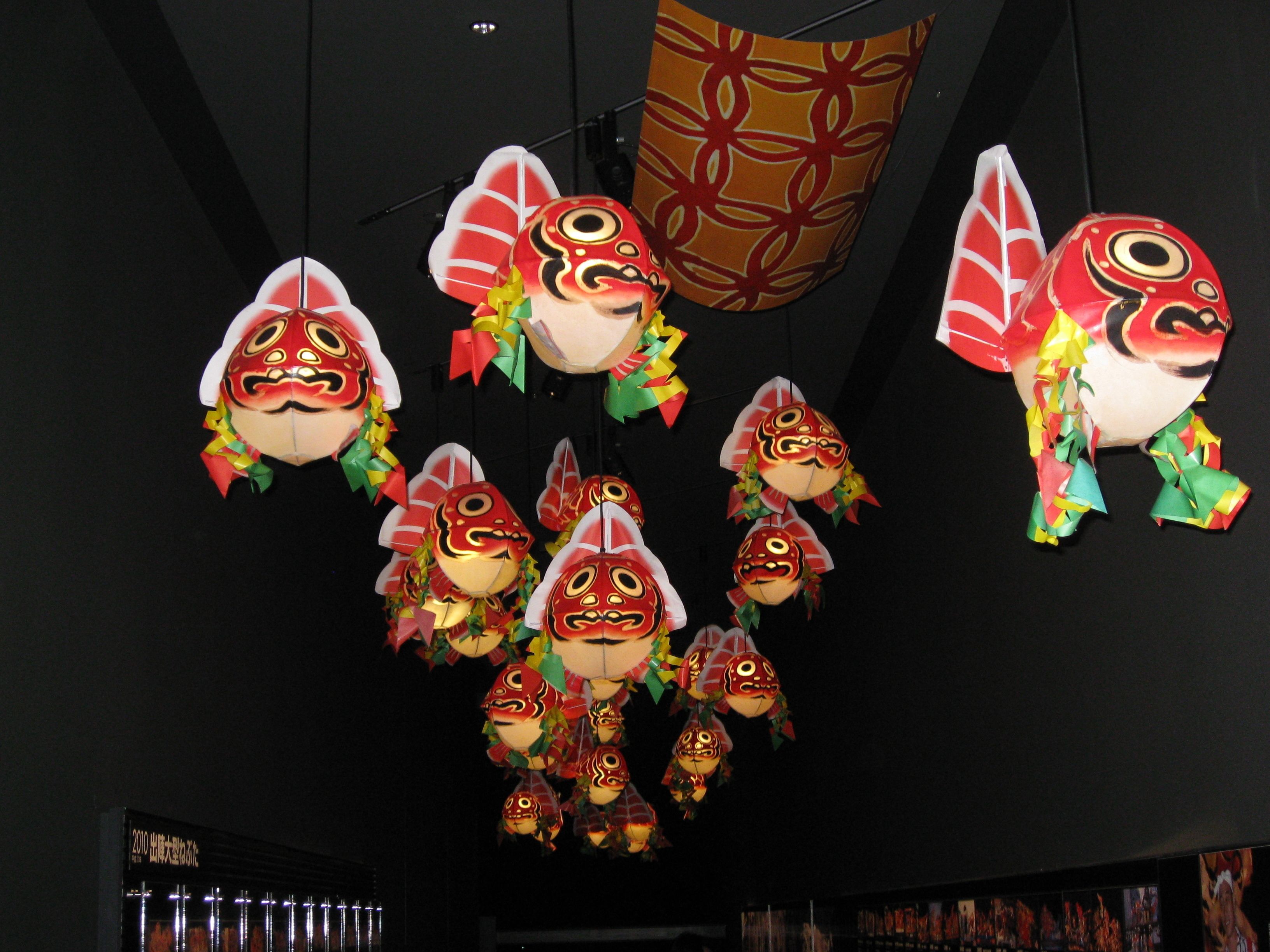 A display of traditional masks hanging from the ceiling.