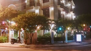 A multi-story building with balconies and a well-lit entrance. - Lantern Villa (Da Nang)