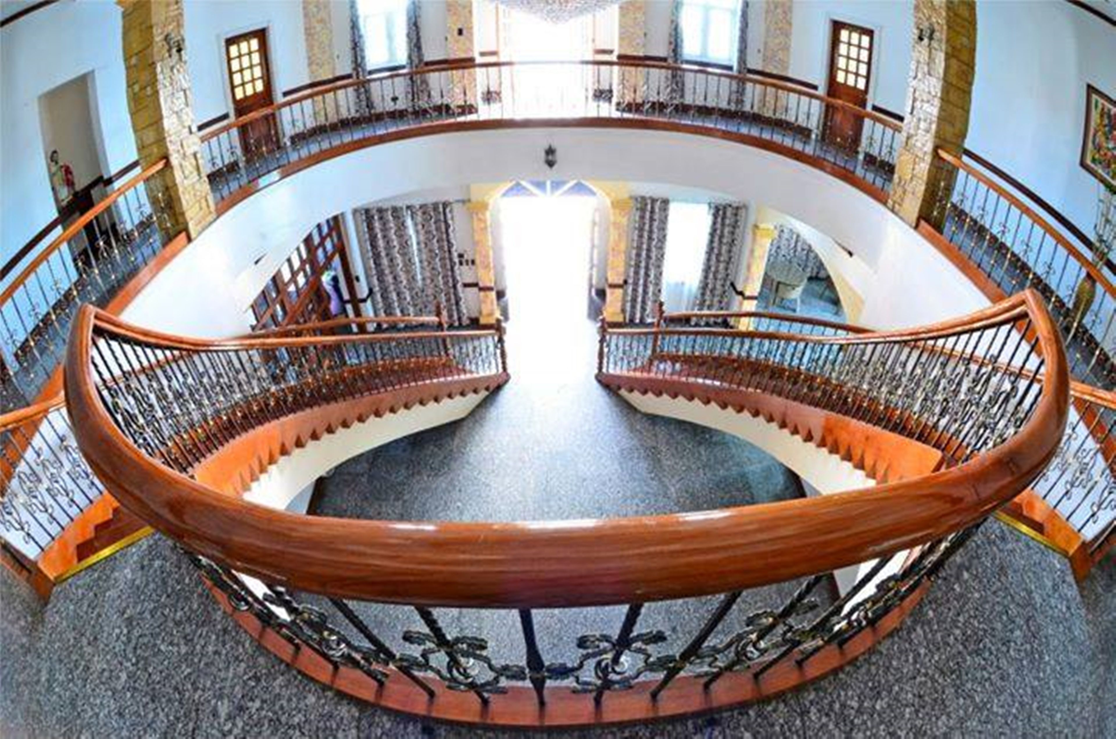 Ein kreisförmiger Innenhof mit einer zentralen Treppe und Geländern.