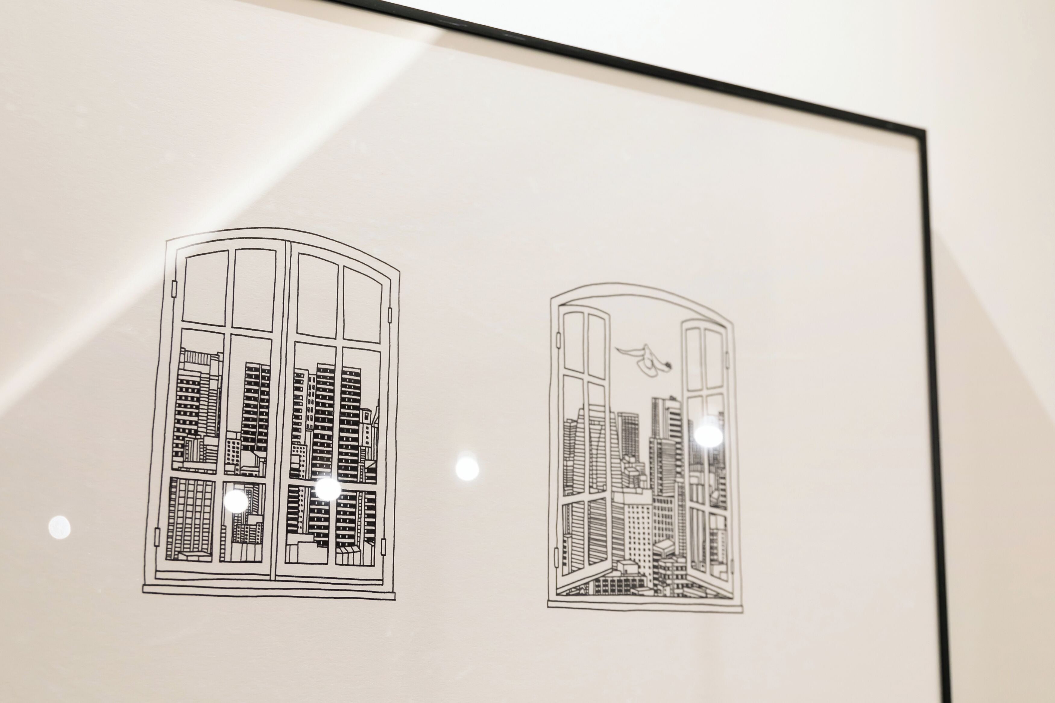 A framed architectural drawing of a building with multiple floors and a central courtyard.