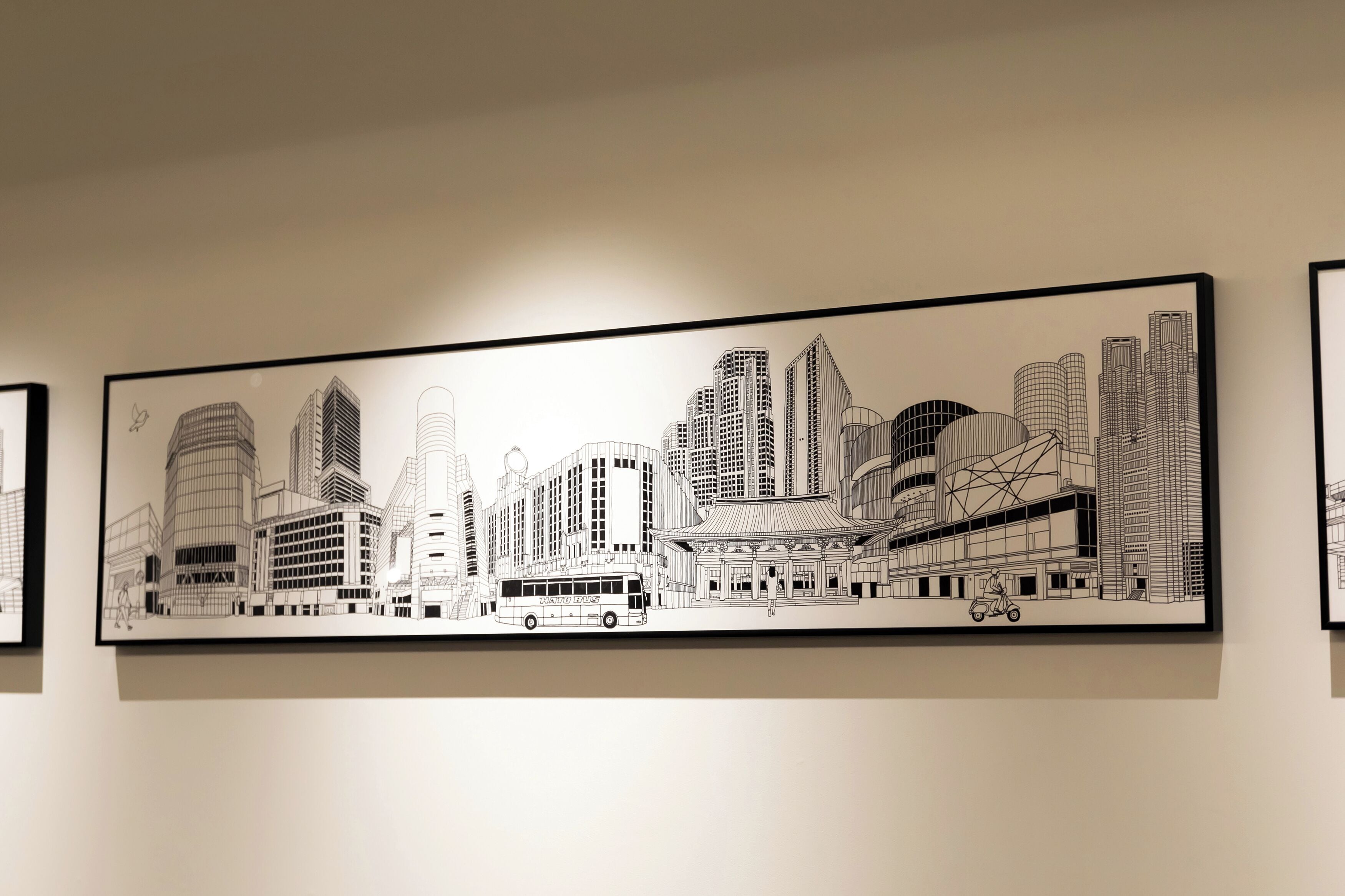 A large black and white cityscape mural on a wall.