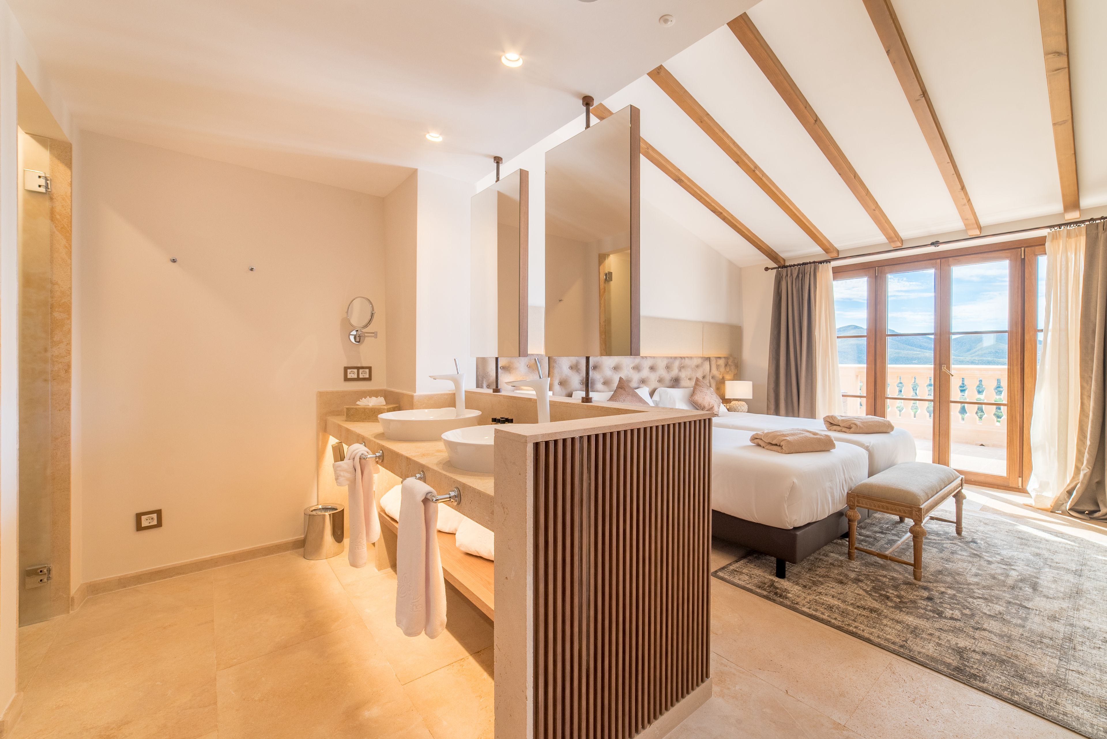 A modern bathroom with dual sinks, a large mirror, and a shower.