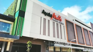 A modern building with a sign that reads "Ayala Malls Capitol Center." - City Center Sleek Studio Deluxe (Bacolod)