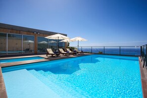 Outdoor pool, open 7:30 AM to 10 PM, pool loungers