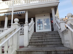 A staircase leading to a building entrance with white balustrades and a star decoration above the door. - La Montaña Palentina (Guardo)