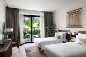 A hotel room with two beds, a desk, a chair, a TV, and a balcony with a view of greenery. - Treeline Urban Resort (Siem Reap)