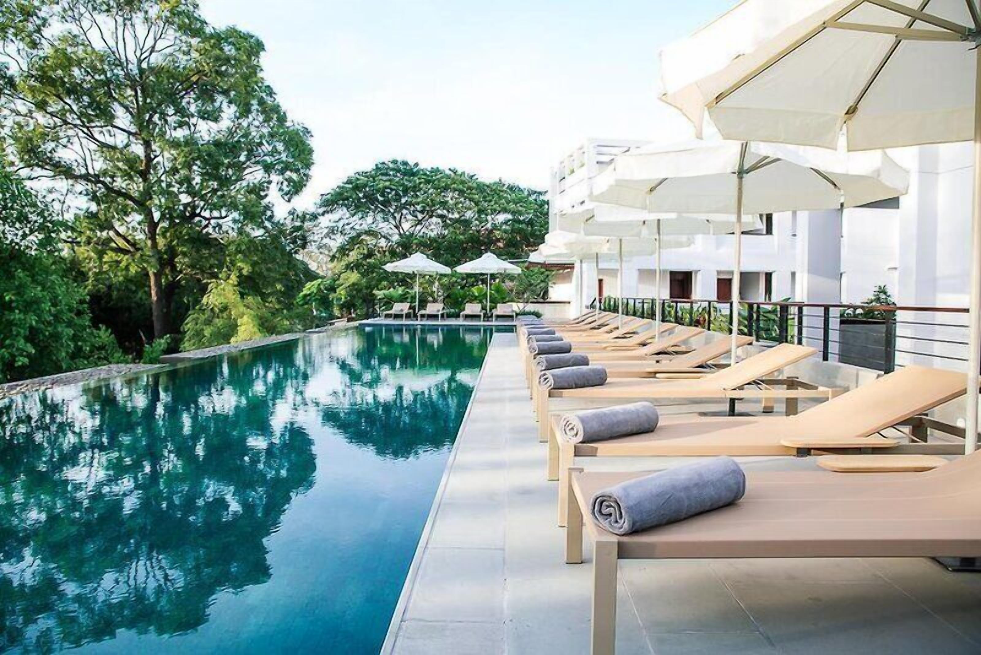 Outdoor pool, open 6 AM to 10 PM, pool umbrellas, pool loungers