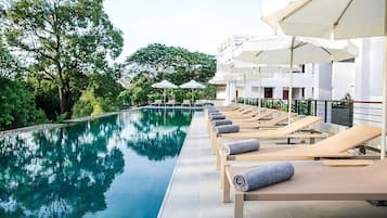 Outdoor pool, open 6 AM to 10 PM, pool umbrellas, pool loungers