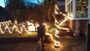 A garden with a decorative light display, a brick wall, and a statue. - Shiralee Bed & Breakfast (Salisbury)