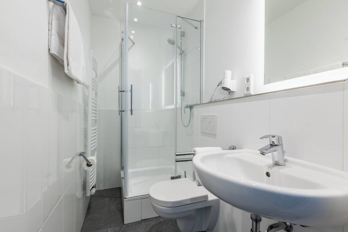 shower, hair dryer, towels, soap