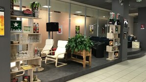 A modern interior with seating areas, a bar, and various amenities.