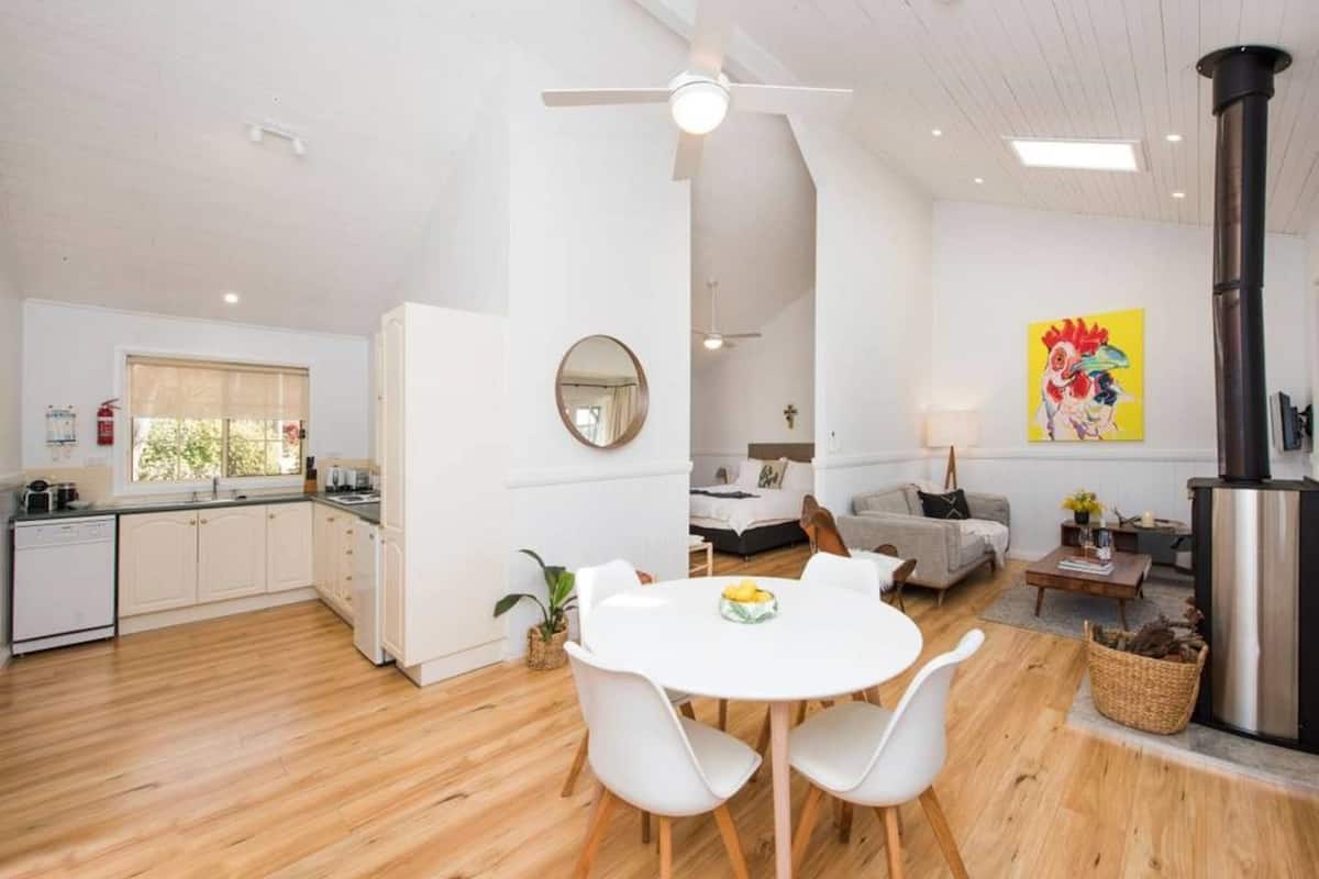 A modern, open-plan living space with a kitchen, dining area, and a cozy seating area.
