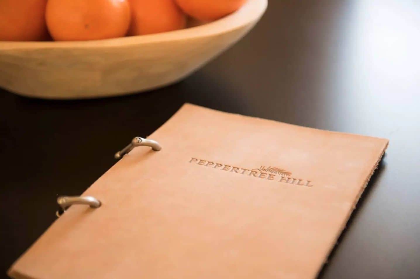 A notebook with "PEPPERTREE HILL" embossed on the cover.