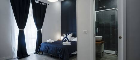 Deluxe Quadruple Room, Balcony | Down duvets, memory-foam beds, individually furnished, desk