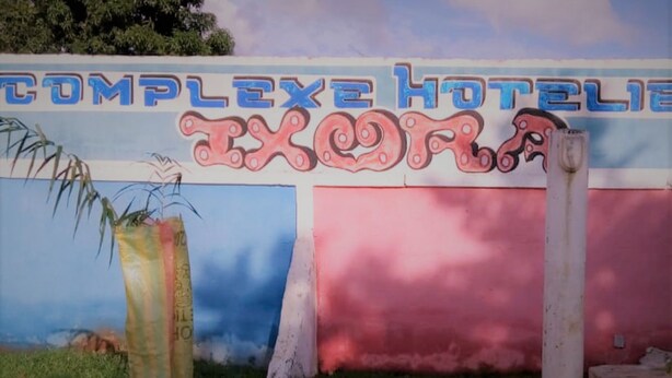 A hotel sign with the name "COMPLEXe HOTEL" and a stylized "X" logo.