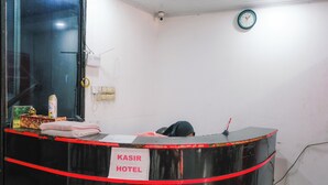 A hotel reception desk with a sign reading "KASIR HOTEL". - King Stone Hotel (South Tangerang)