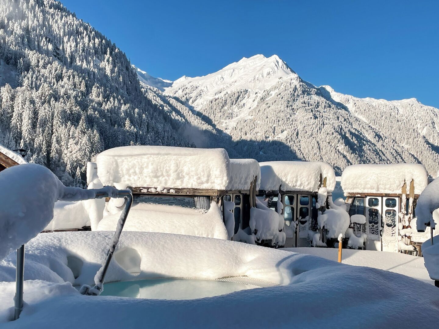 A snow-covered mountain with a clear sky.