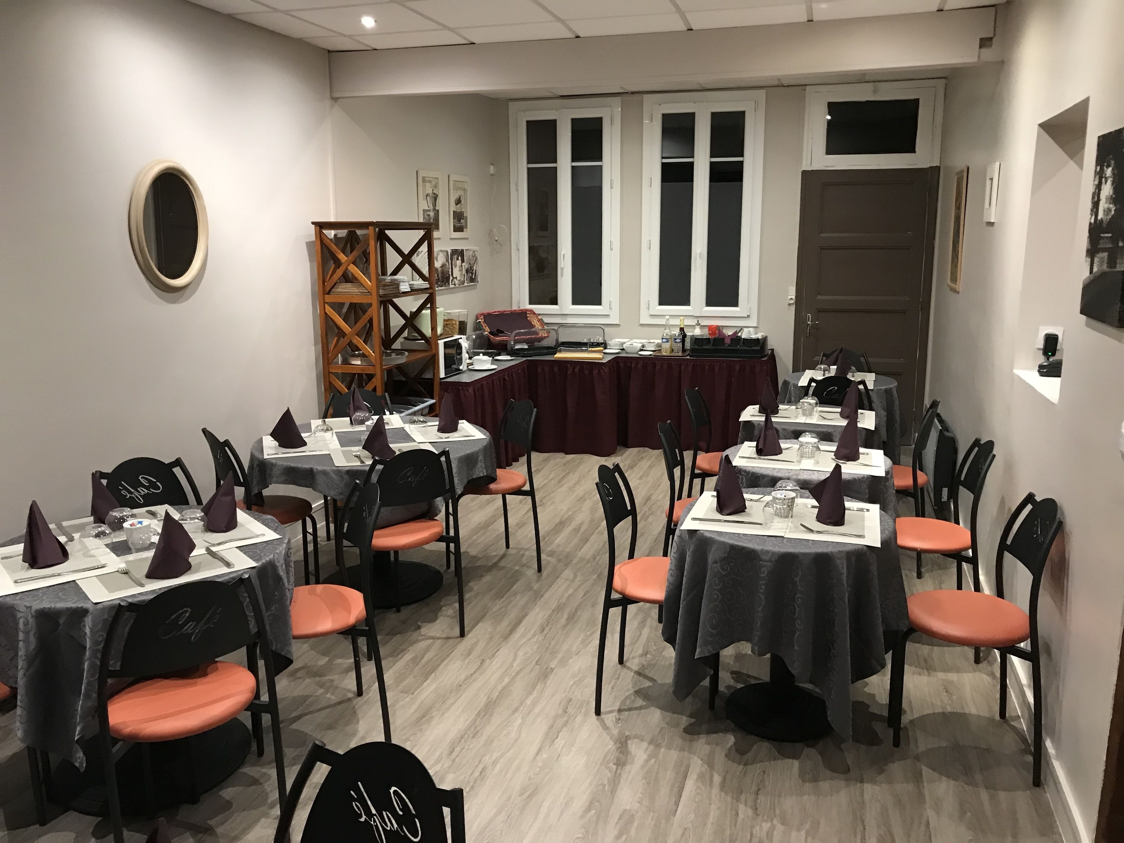 A conference room with tables set for meetings, equipped with chairs and nameplates.