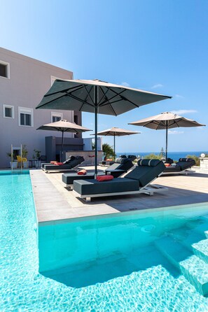 Seasonal outdoor pool, open 9:00 AM to 9:00 PM, pool umbrellas
