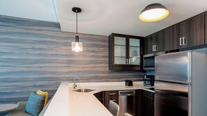 A modern kitchen with a built-in dishwasher, a double oven, and a stainless steel refrigerator. - Residence Inn by Marriott Winnipeg (Winnipeg)